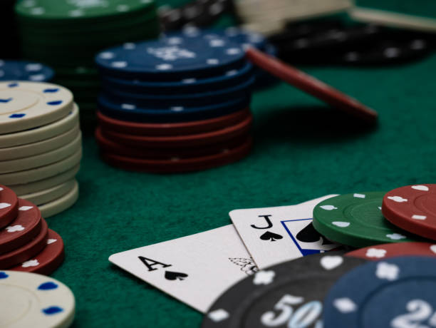 istock poker game table, ace and jack blackjack score with stack of playing chips 1351071572