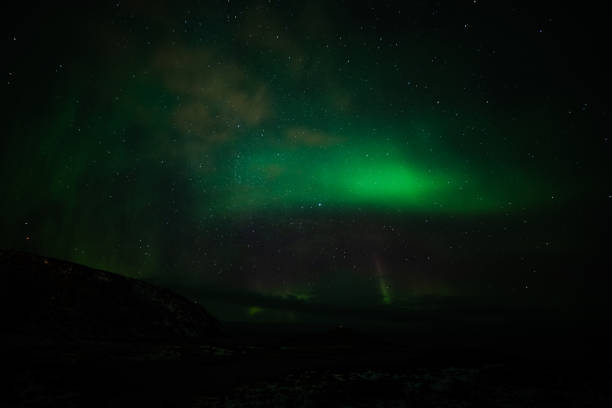 Northern landscape. Winter background with green Aurora Borealis