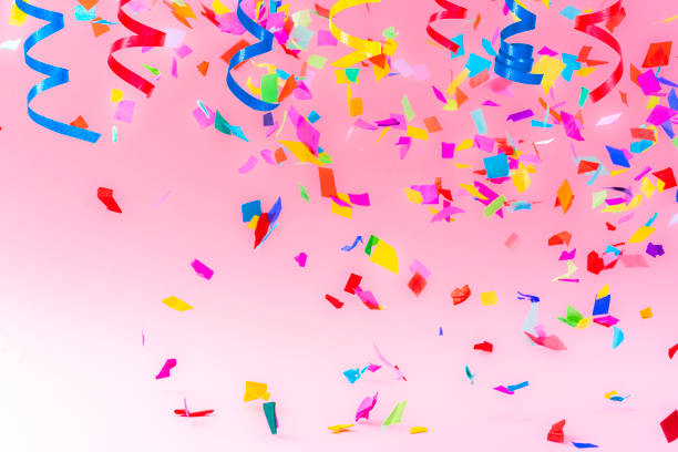 istock Confetti and streamers on pink background 1351073196