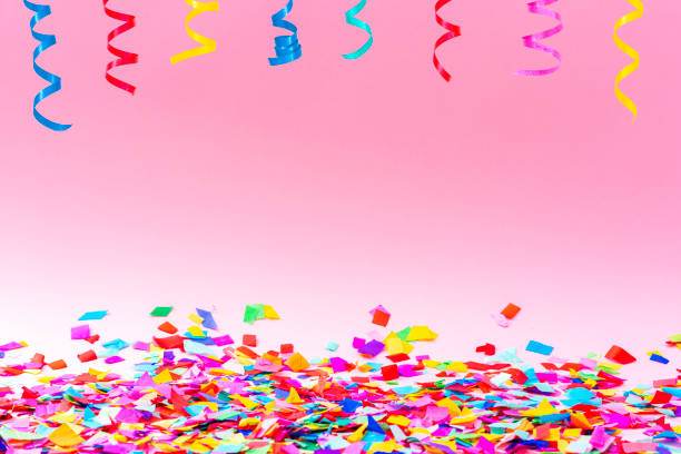 istock Confetti and streamers on pink background. Copy space 1351073199