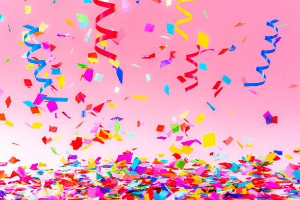 istock Falling confetti and streamers on pink background 1351073204