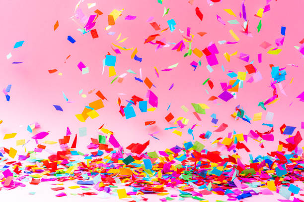 istock Colorful falling confetti on pink background 1351073259