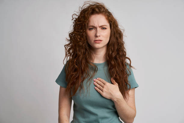 Young woman with pain of chest Young woman with pain of chest heartburn photos stock pictures, royalty-free photos & images