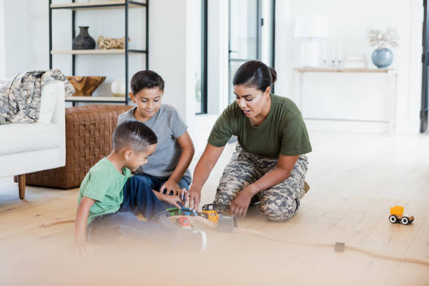 istock Single mom plays on living room floor with sons 1351076104