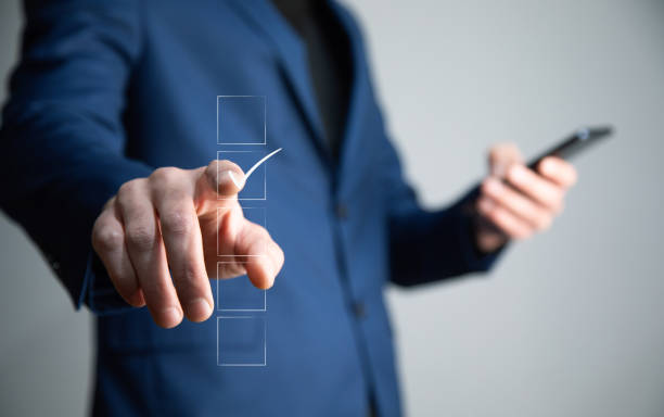 istock man holding phone with accepted icon 1351077618