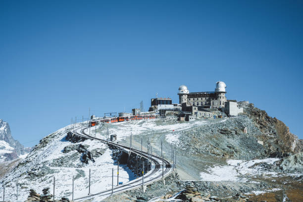 red Gornergrat train coming down the curvy trail from the Gornergrat peak station