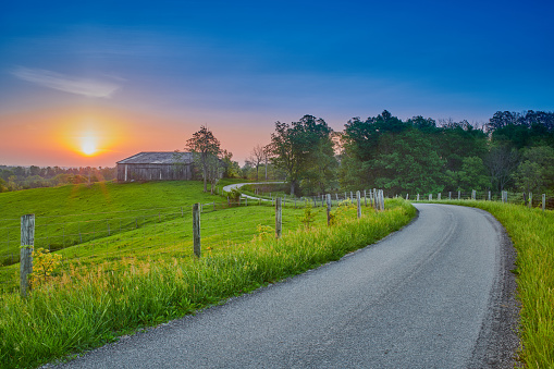 Sunrise Along  a Country Road with Barn.