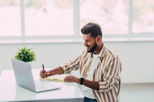 istock Indian business man working with papers and computer working at office 1351079840