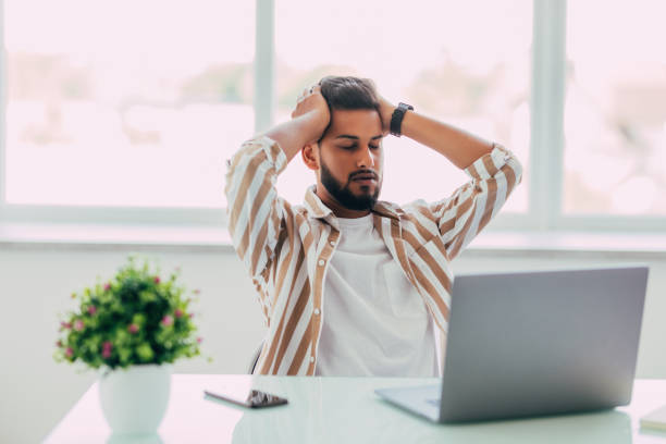 istock Indian business man is frustrated on a table with a laptop 1351081514