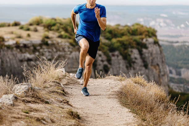 istock male runner run trail on background of mountains 1351081615