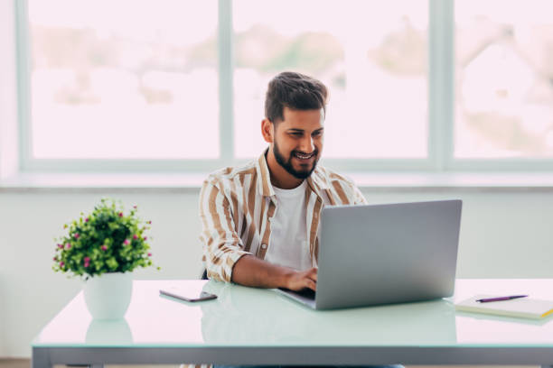 istock Indian man working at office and talking on mobile 1351081716