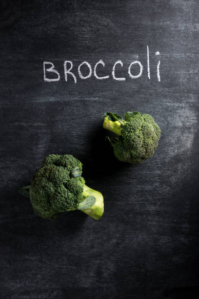 istock Photo of broccoli over dark chalkboard background. 1351082289