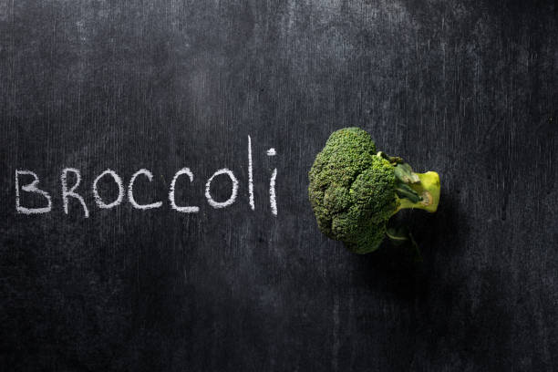 istock Top view image of broccoli over dark chalkboard 1351082842