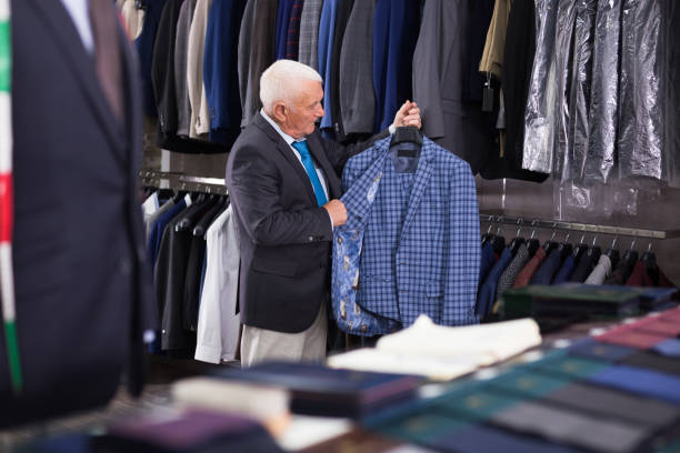 istock Mature customer looking jacket in men clothes store 1351085799