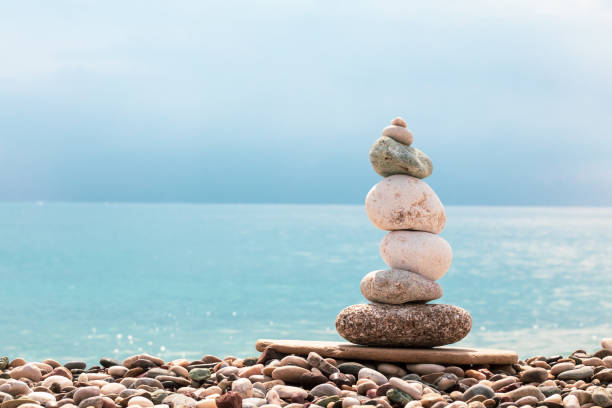 istock Cairn. Turquoise sea. Pebble rocky beach 1351085823