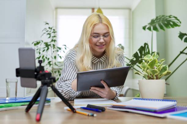 istock Female teenager student using digital tablet and smartphone for study 1351085835