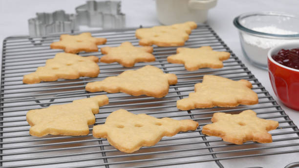 istock Christmas shortbread cookies with raspberry jam recipe, close up baking process. Baked cookies close up on cooling rack 1351087587