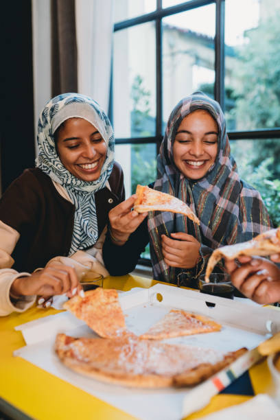 istock Three friends are eating pizza together 1351091089