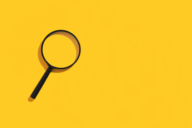 istock Magnifying glass on yellow background. Top view. Flat lay. Copy space. Concept 1351092780