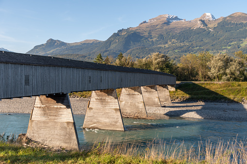 Vaduz, Liechtenstein, October 11, 2021 Old wooden bridge across the rhine river at the swiss border