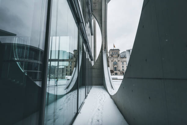 Berlin Reichstag building reflecting in window pane at pale winter day