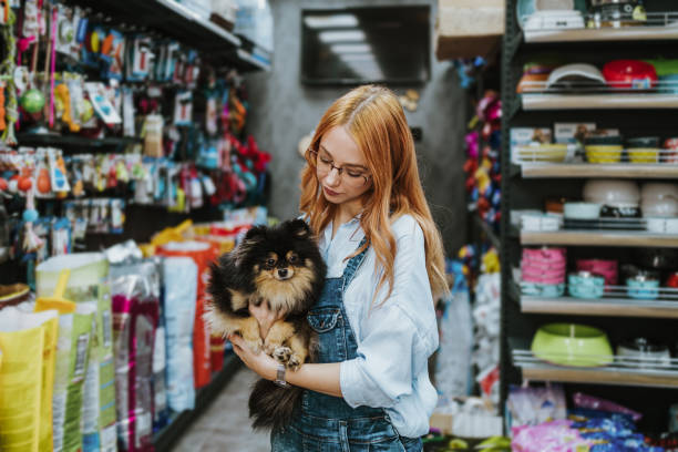 istock Woman in pet shop 1351093795