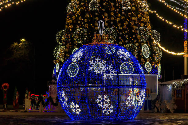 istock Large illuminated Christmas bauble on a city square 1351095810