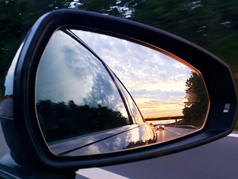 Side mirror of a car with sunset