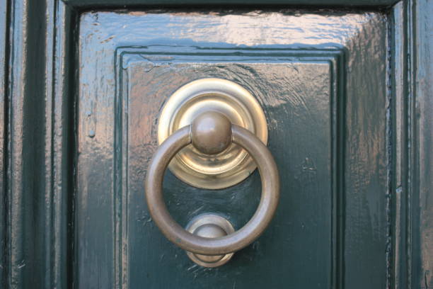 istock Vintage brass door knocker on an old door 1351096741
