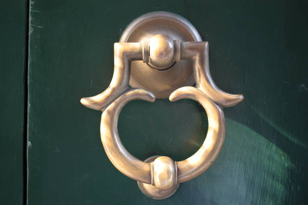 istock Vintage brass door knocker on an old door 1351096830
