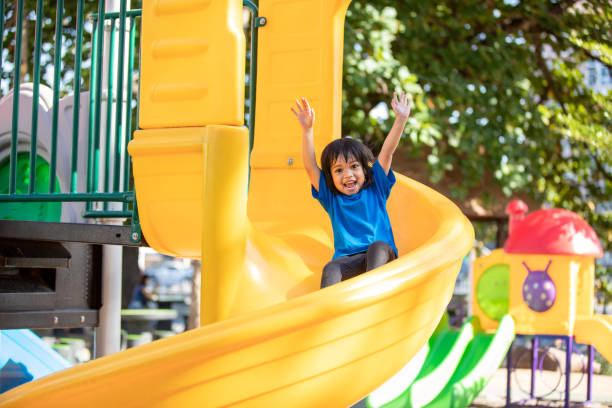 Asian girl playing at the playground and smiled and laughed happy stock photo