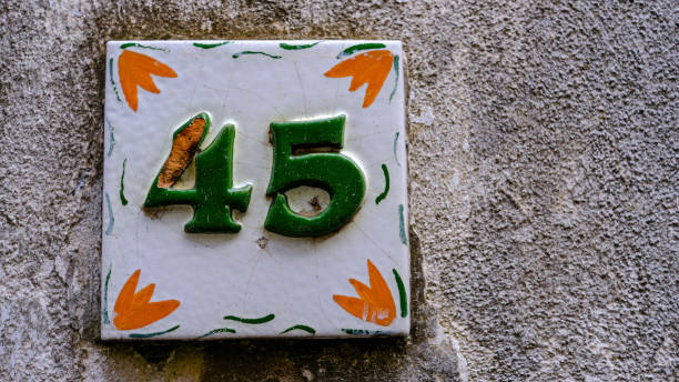 istock Ceramic house number on wall. number forty-five. 45 1351101667
