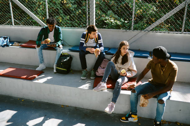 istock High school kids hanging out in school after classes 1351102064