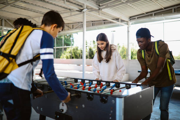 istock High school kids playing table soccer after classes 1351102698