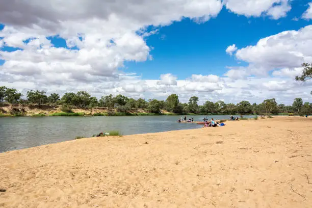 Murray River bank in Mildura, VIC, Australia, with unidentifiable figures of people.