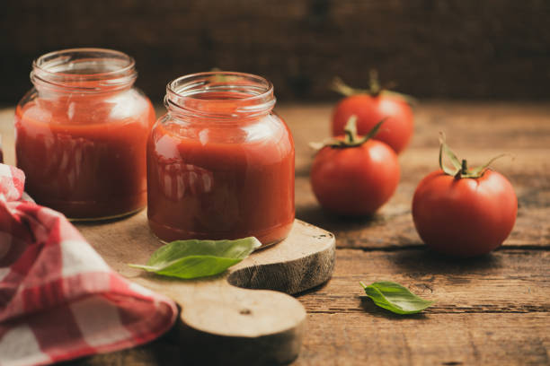 glas hausgemachte klassische tomatensauce auf holztisch - tomatensoße stock-fotos und bilder