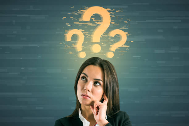 istock Attractive young caucasian woman with glowing question marks on digital background. FAQ and solution concept. 1351107336
