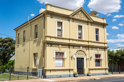 Natimuk, Victoria, Australia - March 2, 2017. Historic building that used to house the National Bank of Australia, in Natimuk, VIC. The impressive two story premises were built in 1908. Because the area was largely swamp lands, its foundations are laid to a depth of approximately 18 feet, and laid on massive redgum slabs. The building has been home to the numerous children of banking families. It is believed by some that the ghost of one little girl still plays on the stairs. Now a private residence.