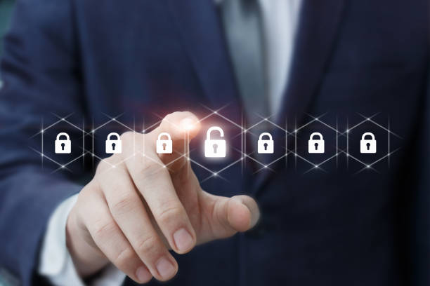 istock Businessman removes protection by clicking on a virtual computer screen. 1351110347