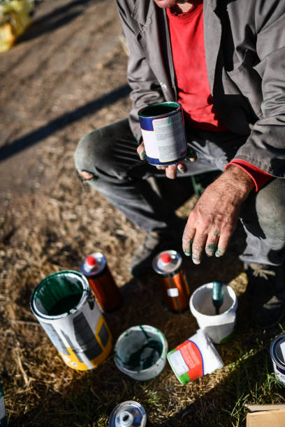 istock Senior Male Mixing And Picking Different Paints For Work Outside 1351113525