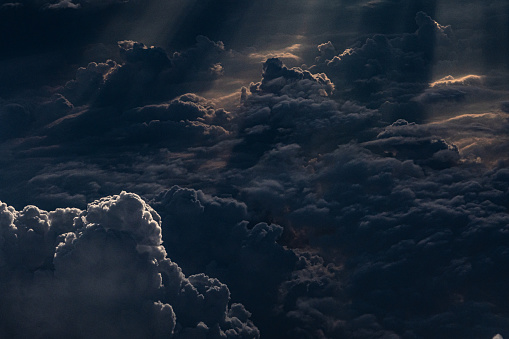 Aerial view of laden clouds and sunset light - dark composition.