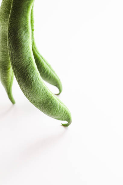 Green bean pods, located on the left. Space for text.