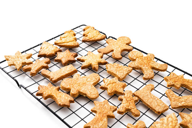 istock Christmas cookies in a cooling rack on white 1351119597