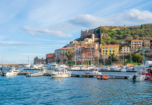 Monte Argentario, Italy - 19 January 2020 - A view of the Argentario mount on Tirreno sea, with little towns; in the Grosseto province, Tuscany region. Here in particular Porto Ercole village with a cityscape and port