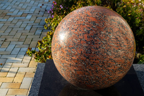 istock Polished red granite balls as decorations in a public park 1351124570