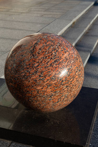 istock Polished red granite balls as decorations in a public park 1351124579