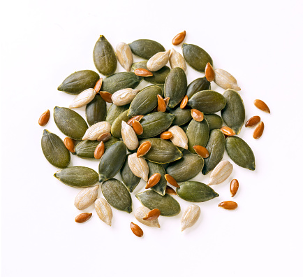 Eating sunflower seeds, hand taking sunflower seeds from a bowl