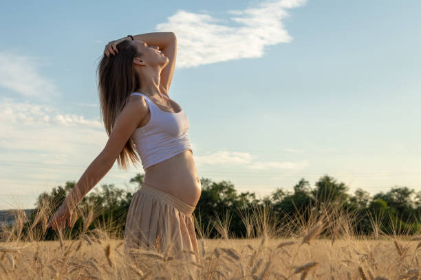 istock Pregnant woman relaxing outdoors during sunset 1351129055