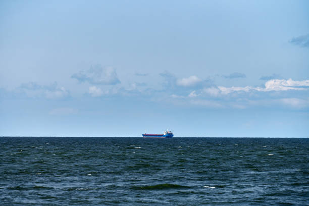 istock Container cargo ship freighter, import export trade logistic transportation, cargo ship in blue sea 1351129197