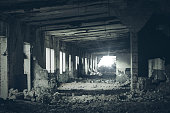 Abandoned building interior, ruins of industrial factory, dark corridor in scary abandoned premises